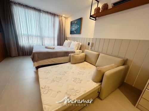 a bedroom with a bed and a couch and a bed at Emunah-Ponta de Campina Cabedelo in Cabedelo