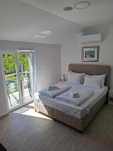 a bedroom with a large bed and a sliding glass door at Villa HS in Mostar