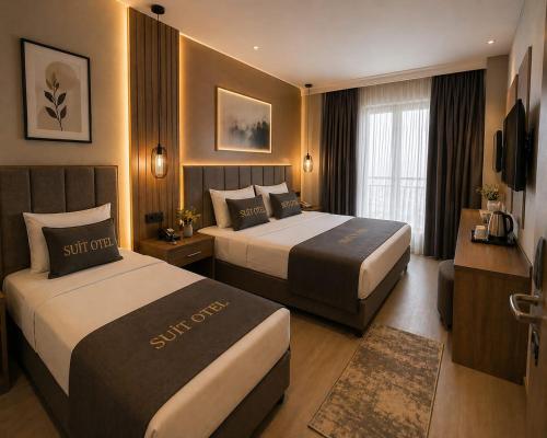 a hotel room with two beds and a television at Simge Suite Hotel in Istanbul