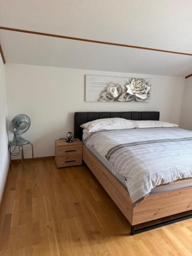 a bedroom with a bed and a wooden floor at Mountain and Lake in Bönigen