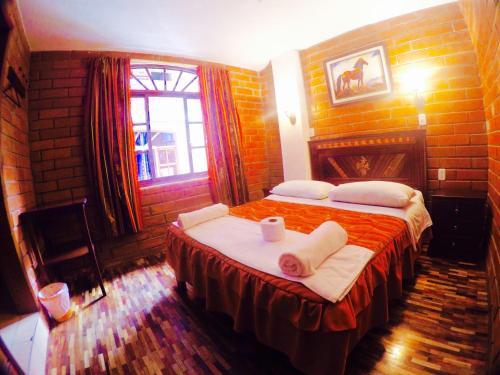 um quarto com uma cama com toalhas em Hostal Nomada em Baños