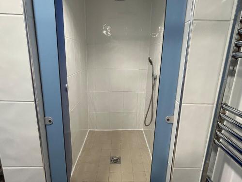 a shower in a bathroom with a glass door at Natures Nest in Malton