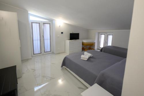 a bedroom with a bed and a television in it at Dimora Ambrosio 108 in San Giuseppe Vesuviano