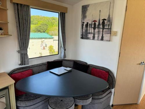 a meeting room with a table and chairs and a window at Cornish Dreams - WiFi in Newquay