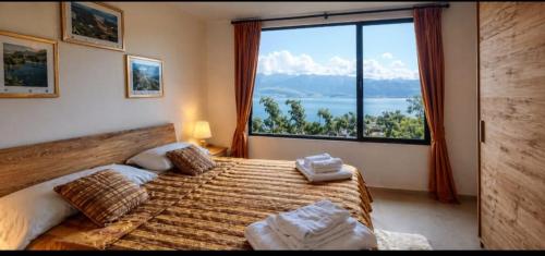 a bedroom with a bed with a large window at INCANTO Golden Place B&B in Reggio di Calabria