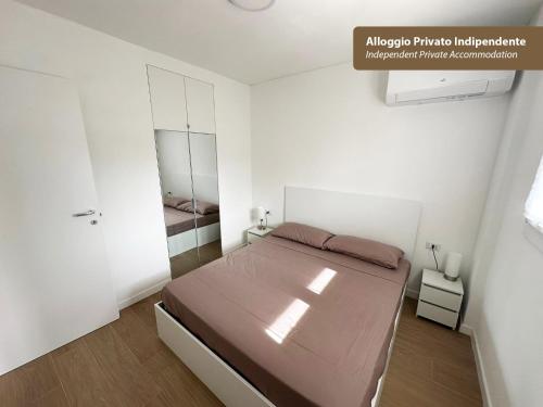 a bedroom with a large bed in a white room at Isola Chiara in Cagliari