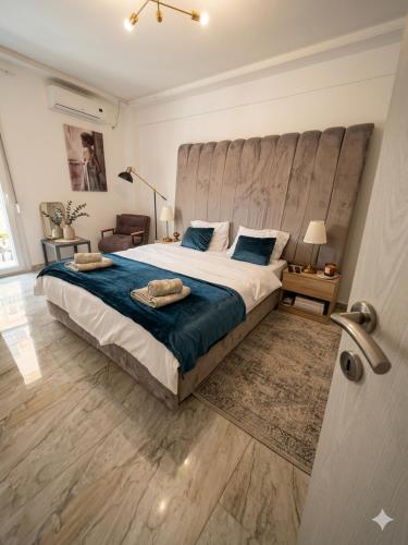 a bedroom with a large bed with a large headboard at Dimi Deluxe in Perea