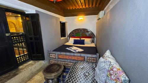 a small bedroom with a bed and a balcony at Palais Doha & SPA in Fez