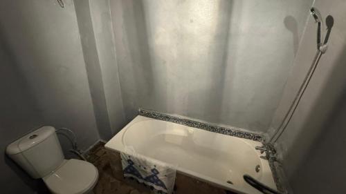 a small bathroom with a toilet and a shower at Palais Doha & SPA in Fez
