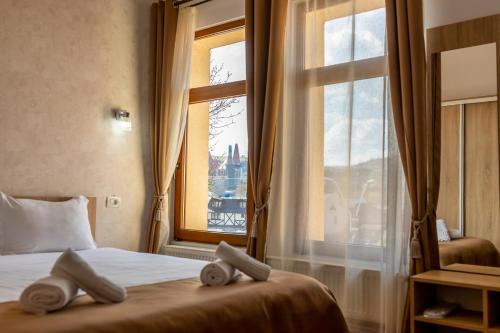 a hotel room with a bed and a window at MARCONI GUESTHOUSE in Hunedoara