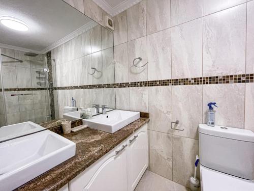 a white bathroom with a sink and a toilet at Rondevoux 17 in Margate