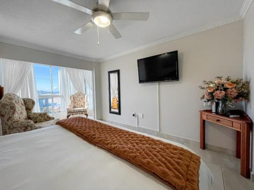 a bedroom with a large bed and a flat screen tv at Rondevoux 17 in Margate