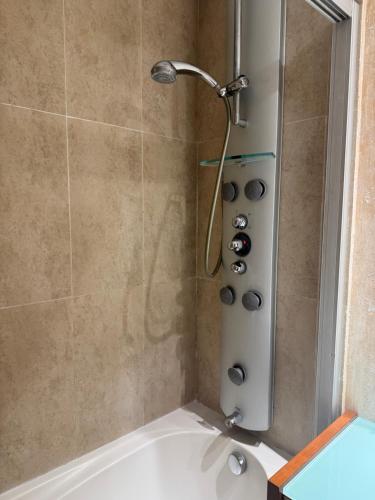 a shower with a shower head in a bathroom at Suitte Catalunya in Calafell