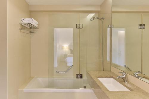 a bathroom with a tub and a sink and a shower at Grace Smart Design Hotel - "Hotel Anjo de Portugal" in Fátima