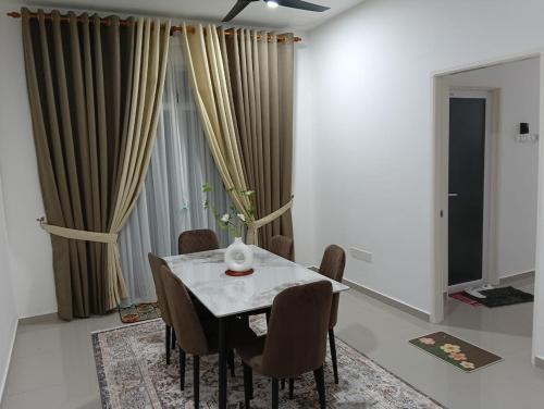 a dining room with a table and chairs at SD Homestay in Bachok