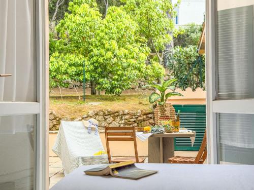a view of a patio with a table and chairs at Orizzonte Blu - HelloElba in Marciana Marina
