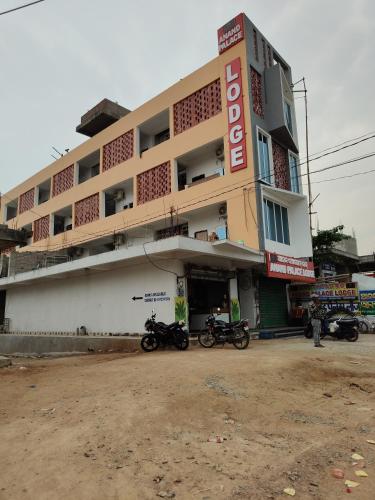 a building with motorcycles parked in front of it at Anand palace lodge in Ghatgān
