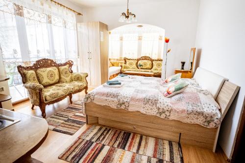 a bedroom with a bed and a couch at Hotel Vyšehrad in Turčianske Teplice