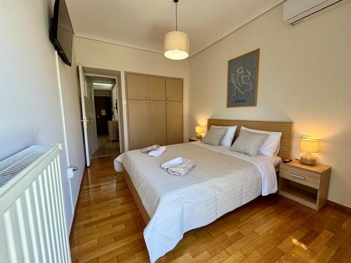 a bedroom with a bed with two towels on it at Alimos Signature in Athens