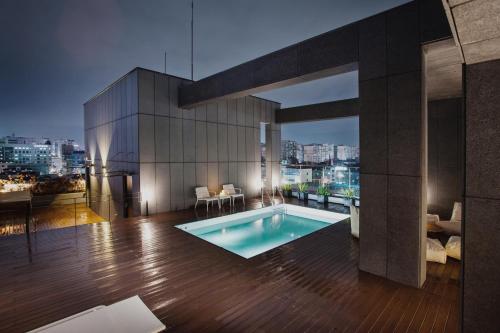 a swimming pool on top of a building at Hotel Gaden in Suwon