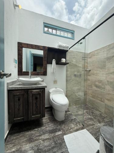 a bathroom with a toilet and a sink and a shower at HOTEL BOUTIQUE Santa Helena in Villa de Leyva