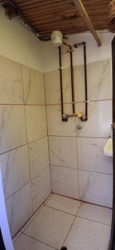 a bathroom with a marble shower with a sink at Coco's vibes in Ollantaytambo