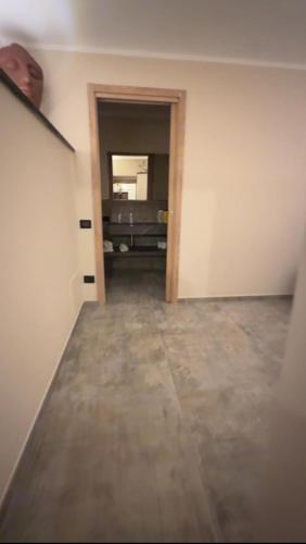 an empty room with a door and a hallway at Alloggio del Trap in Ferentillo