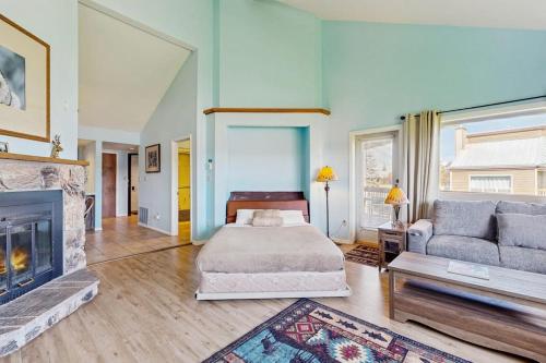 a bedroom with a bed and a fireplace at Aspenwood 4229-30 in Pagosa Springs