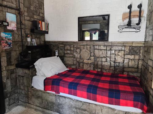 ein Bett in einem Zimmer mit einer Steinwand in der Unterkunft Casa Jazz in Salinas
