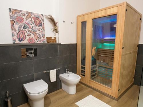 a bathroom with a toilet and a sink at Costa Ovest Apartment 3 in Nurachi