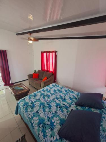 a bedroom with a bed and a couch at Hanivai Beach Bungalow in HUH