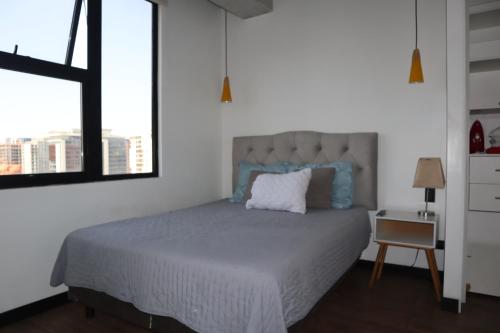 a bedroom with a large bed and a window at EON Two Bedroom Apartment 1303 in Estación Pamplona