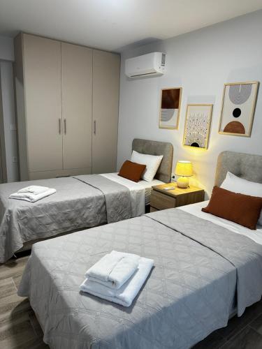 a room with two beds with towels on them at Oleana Grand Appartment in Lampi