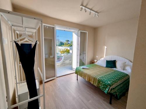 a bedroom with a bed and a sliding glass door at La Papessa in Savio di Ravenna