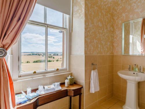 a bathroom with a sink and a window at 5 Bed in Melrose oc-89348 in Newtown Saint Boswells