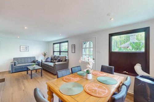 a living room with a wooden table and a dining room at Lazy Daze in Wasaga Beach in Wasaga Beach