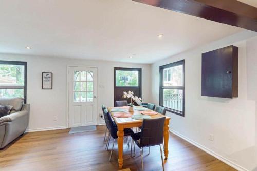 a dining room with a table and chairs at Lazy Daze in Wasaga Beach in Wasaga Beach