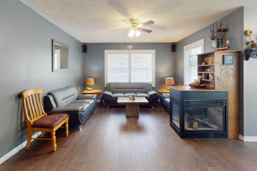 a living room with a couch and a fireplace at Wavy Daze in Wasaga Beach in Wasaga Beach