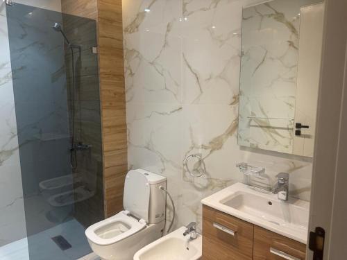 a bathroom with a toilet and a sink and a shower at tanger in Oulad Akkou