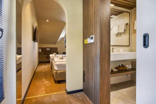 a hallway leading to a room with a bed at Motel Reich in Velenje