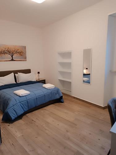 a bedroom with a blue bed in a white room at Maison MariEtt - Smart & Living Suites - in Troia