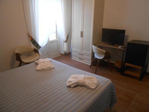 a bedroom with a bed with two towels on it at Verde Luna B in Orbetello