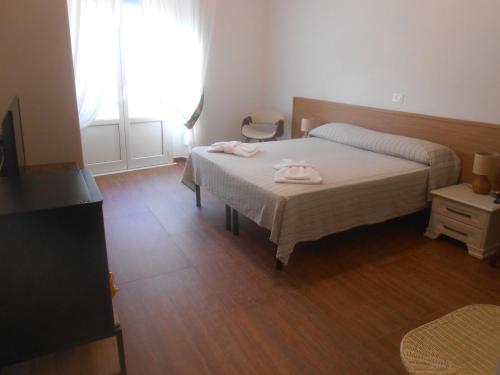 a bedroom with a bed with two towels on it at Verde Luna B in Orbetello