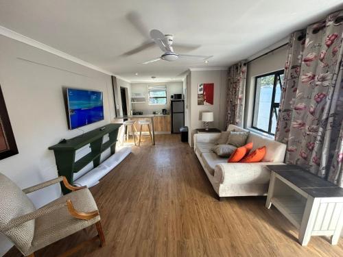 a living room with a couch and a table at Meerlust Cottage in Cape Town