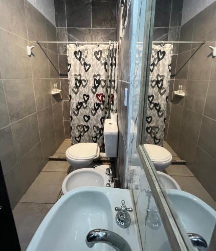 a bathroom with two toilets and a sink at La Bodeguita in Trinidad