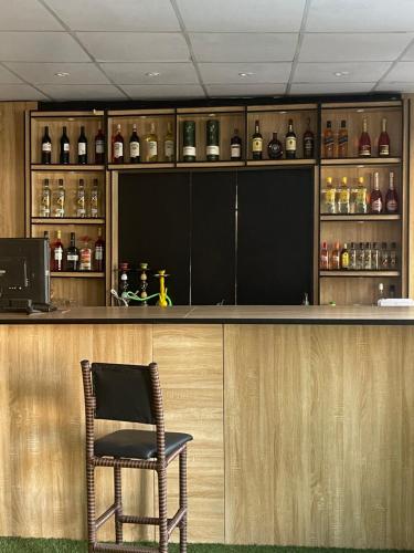 a bar with a chair sitting at a counter at Montevar Hotel in Benin City
