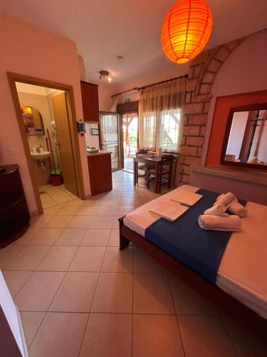 a bedroom with a bed with towels on it at Simos Apartments in Korinos