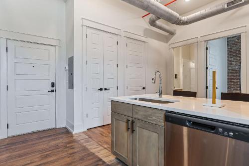 a kitchen with white cabinets and a sink at Southern Blue in McMinnville