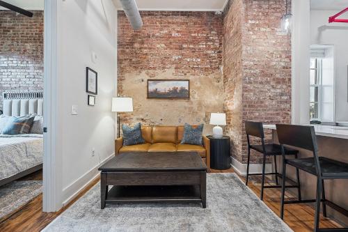 a living room with a couch and a brick wall at Southern Blue in McMinnville