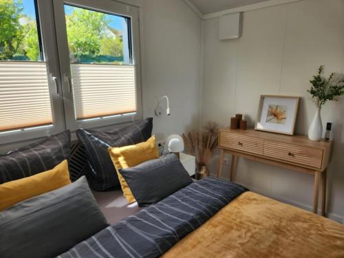 a living room with a bed and a couch at Bei Herze - Tiny Wohnen im Odenwald in Bad König